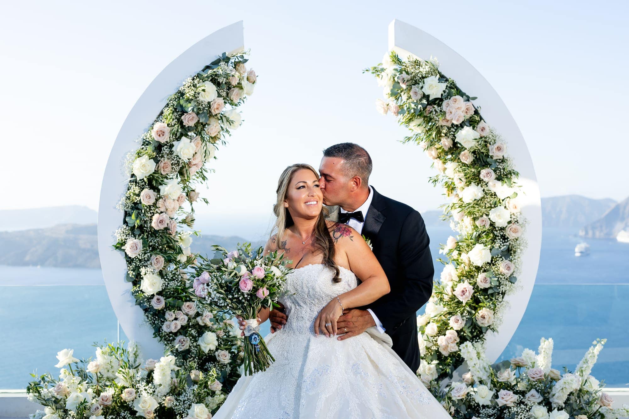 Mary & Chris — A crescent of flowers beside an old windmill, Windmill venue on the caldera, Santorini